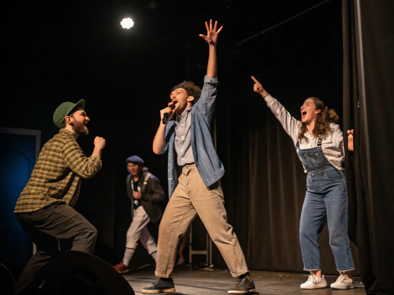 A dynamic image of a theater workshop, featuring participants engaged in an improvisational acting exercise, with expressive gestures and animated facial expressions, highlighting the collaborative and engaging nature of theater at FEET ON THE GROUND.